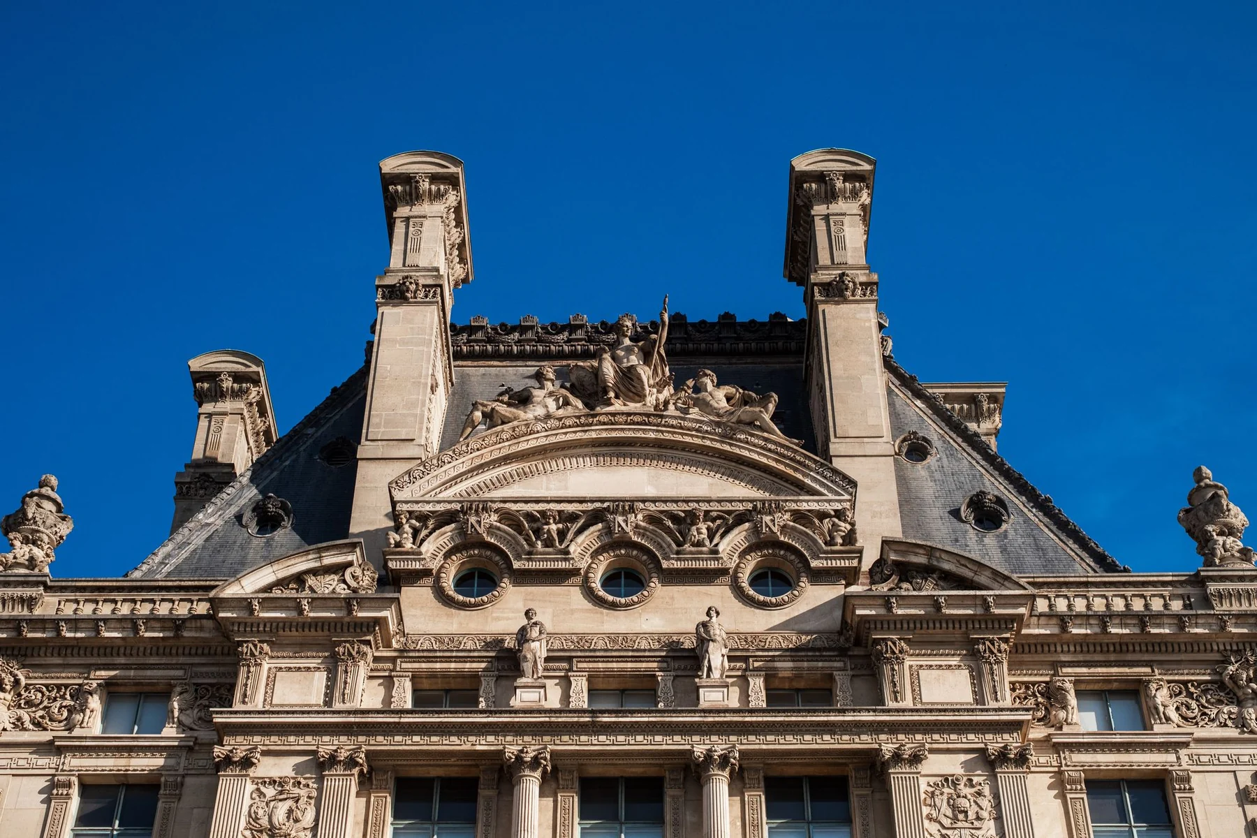 Detailed view of the Louvre Museum's Renaissance architecture in Paris, France.
