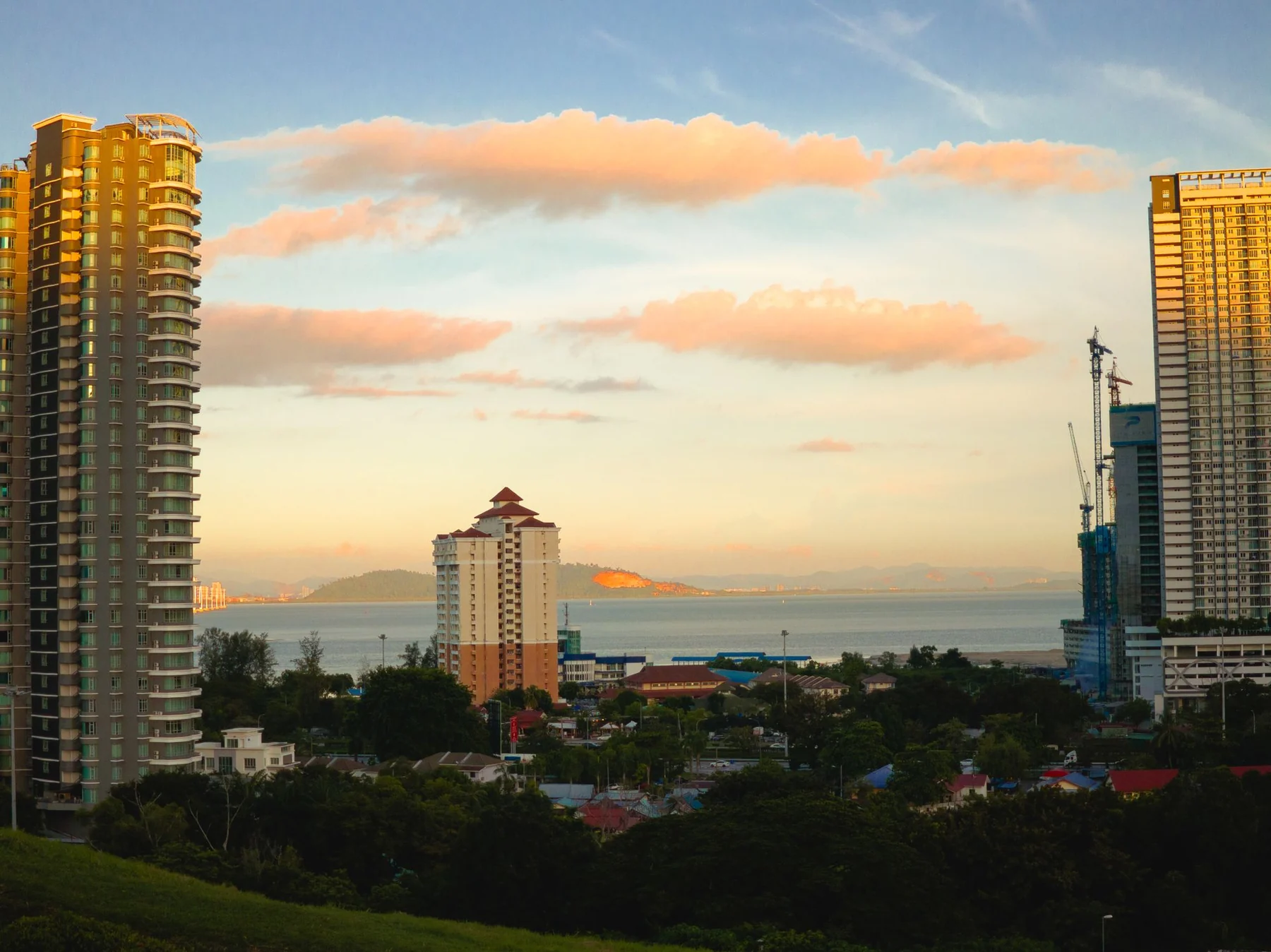 Golden hour cityscape view of Gelugor, Pulau Pinang, Malaysia with coastal background.